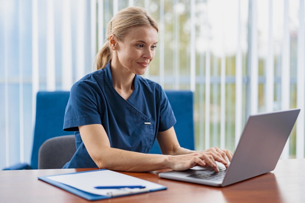 Easy-to-Use Home Care Software concept, caregiver sitting on a desk while using computer