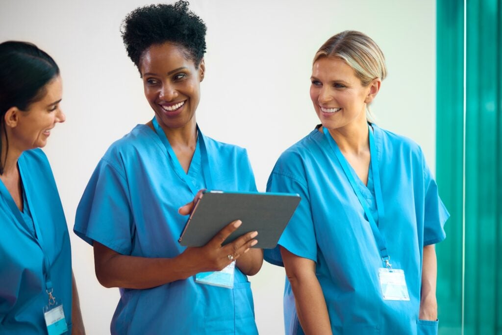 team of caregivers smiling while talking to each other, concept of homecare software