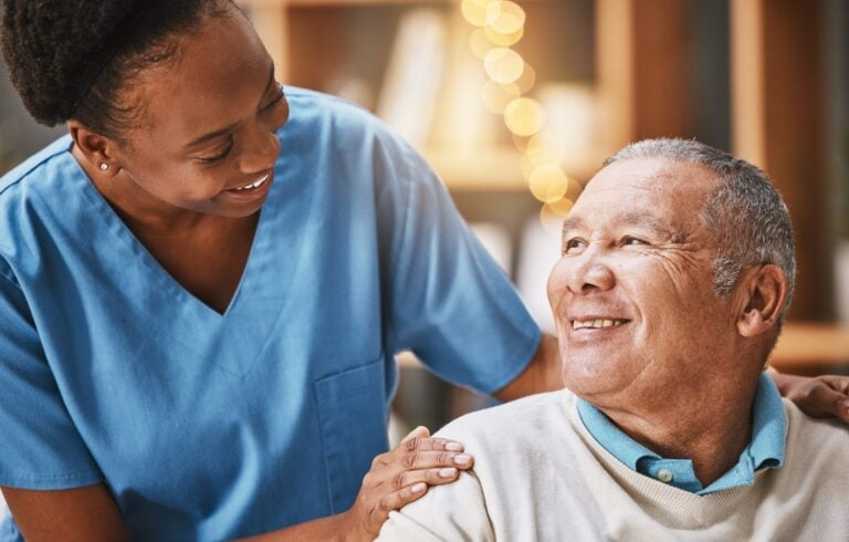 caregiver offering support and guidance to male patient or client in home care