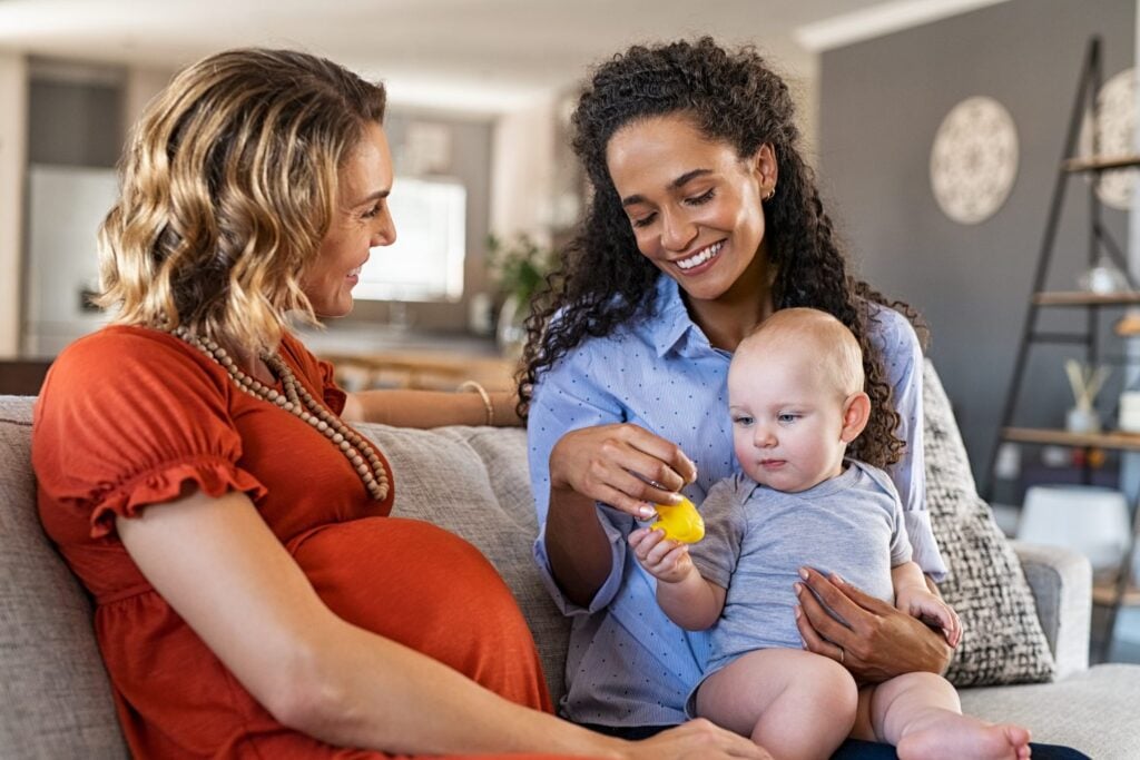 mother and childcare nanny happily talking to each other, concept of client satisfaction