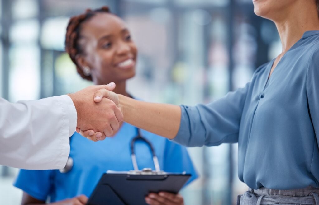 caregiver hiring, female caregiver hiring process, image of a handshake