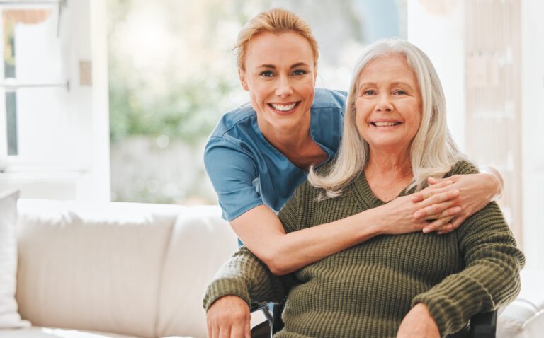 female caregiver hugging an elderly woman client in a wheelchair, concept of home care (1)