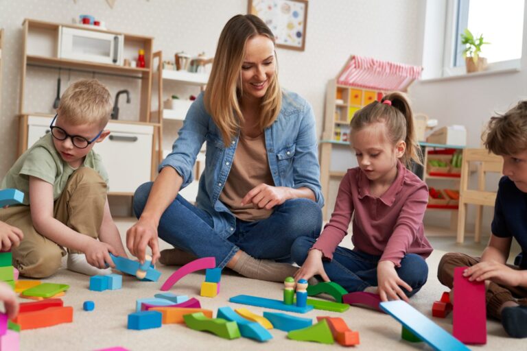 nanny playing with children in a playroom, concept of childcare