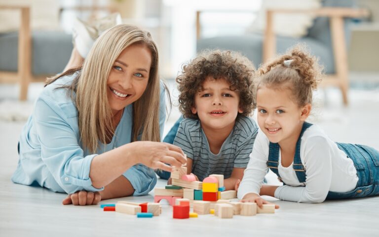 nanny plays with children at home, concept of childcare