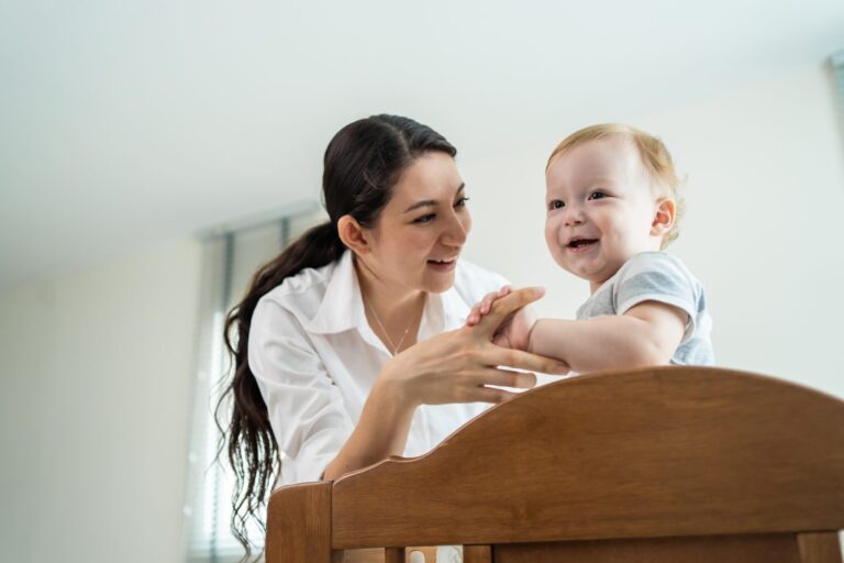 babysitter playing with a toddler at home, concept of babysitting and child services