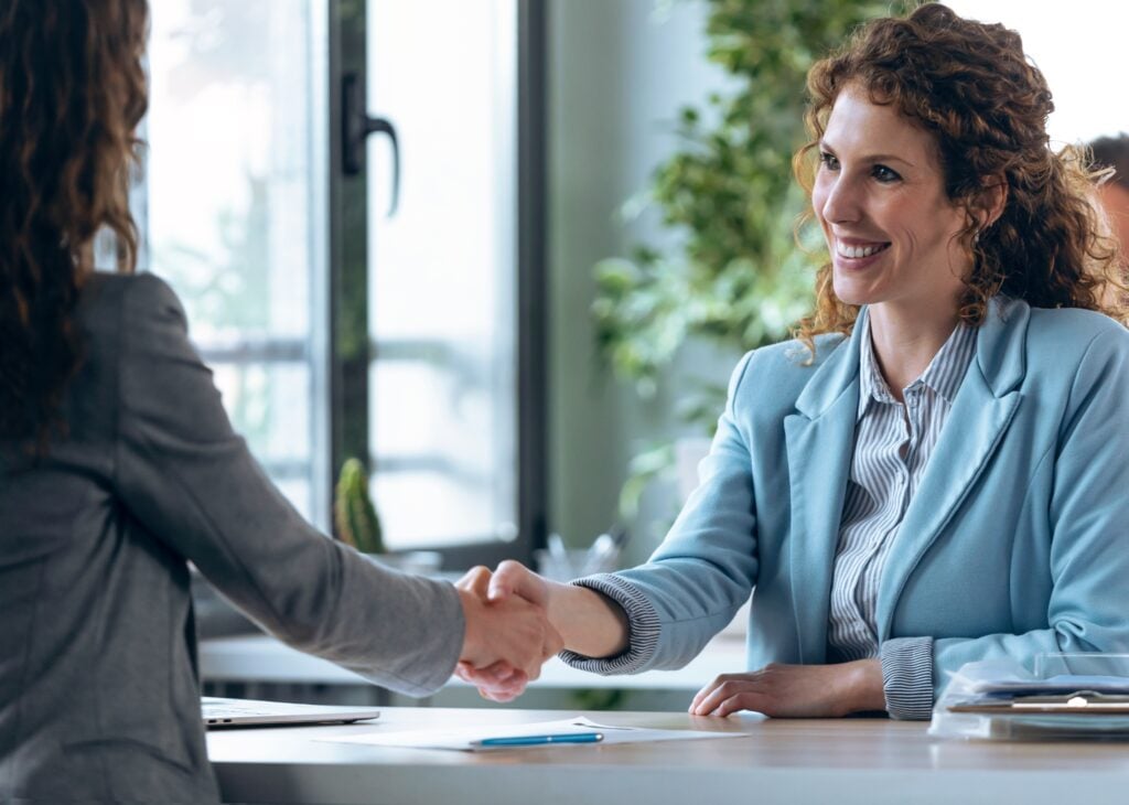 handshake between women, concept of recruitment hiring, childcare, nannies