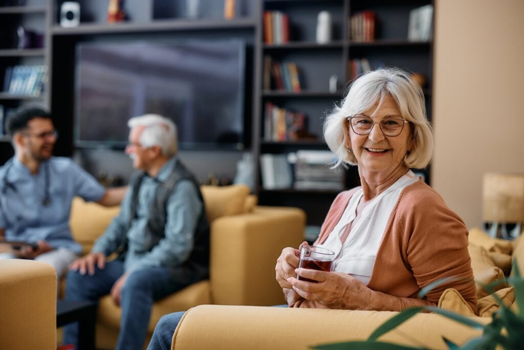 image of a senior woman enjoying cup of tea, image of senior man with caregiver in the background