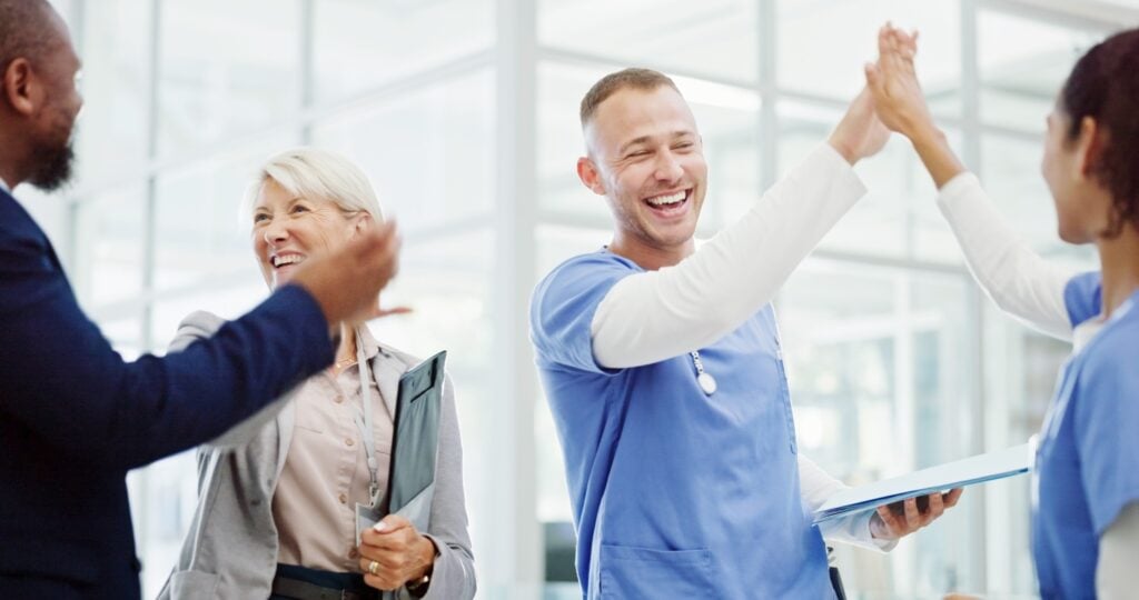 management team and caregivers celebrating and congratulating each other, concept of job recognition