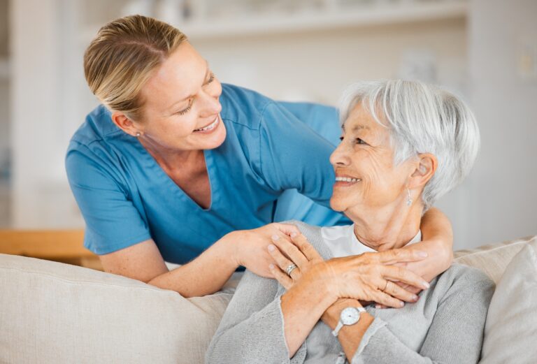 A caregiver puts her arm around a happy senior woman, concept of healthcare, elder care, nursing