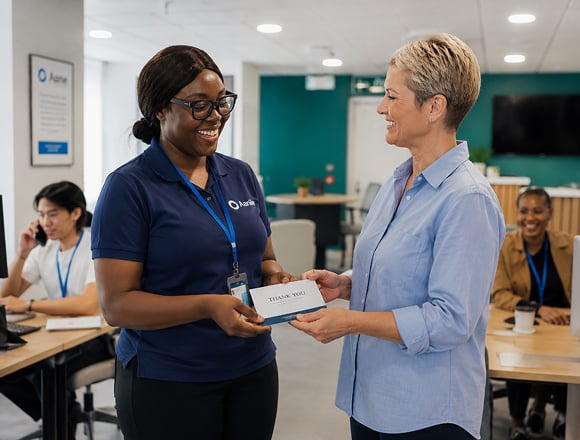 Senior living administrator recognising a caregiver through an employee rewards program