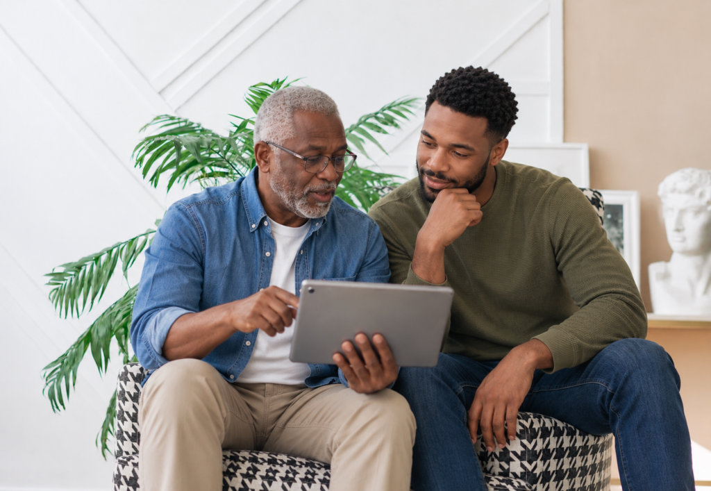 Adult son helping her elderly father complete digital home care onboarding forms