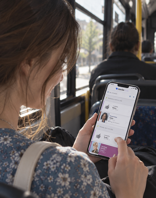 Woman using a mobile booking app to review childcare bookings